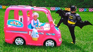 Niki in a pink car meets superheroes