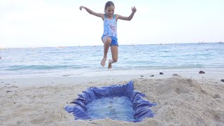 Children play on the beach. Sand pool. 4k