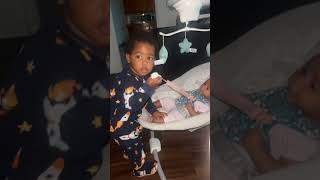 Toddler tries to steal his baby sister's pacifier!