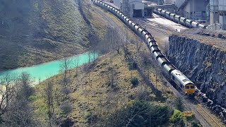 Train passes blue lagoon deep within huge Derbyshire quarry