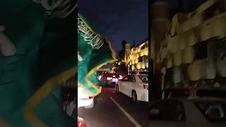 On a traffic jam with waving flag on saudi national day celebration.