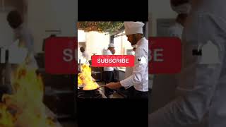 Chef cooking flambe in a pan looking focused#foodies.