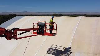 Softwashing a vinyl riding arena.