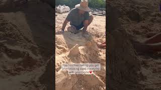 Just a little girl and her dad digging in the sand🏝