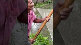 Old man catching fish after reining