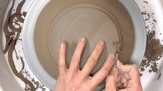 Trimming wide rimmed plates on the pottery wheel