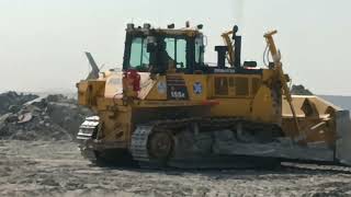 Caterpillar 155A And Komatsu 155A Bulldozers Pushing Soil On Huge Mining Area