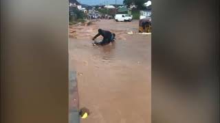 Tragedy As An Okada Rider Is Swept Away By Floodwaters At Chikakore Bridge In Kubwa, Abuja."