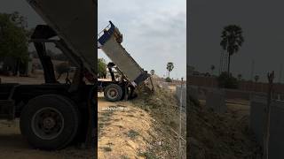 Dump Truck Unloading Land Near Fence #truck #heavymachinesandconstruction #soil #landleveler