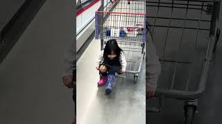 Baby takes on Costco with mismatching boots