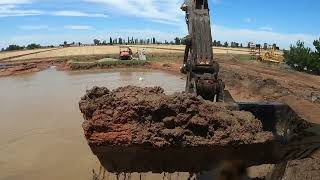 380-Removing mud from what's called a dam in Australia a Pond in Usa