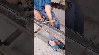 Craftsmen use traditional techniques to sharpen the saw teeth