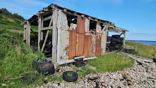 Abandoned corrugated iron shed for old tyre storage at Golspie beach