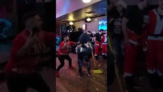 drunk man backflips inside of a bar in Hoboken during Santacon