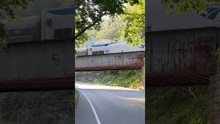 Fast train going up mountain over bridge Amtrak Cardinal