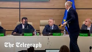 Shocking moment Georgian politician throws paint over election chief