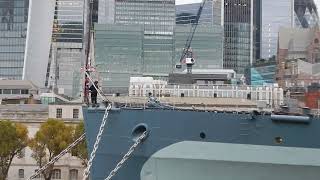 HMS Belfast, raising the colours at 8am, October 2024. The ships naval routines are continued.