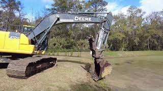 Cleaning Weeds Out of a Pond with big excavator