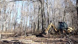 Case 580L Turbo Pushing Over Trees