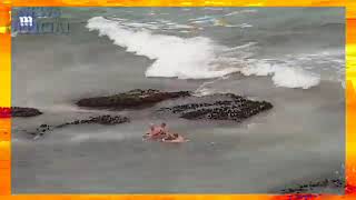 Police on jet skies get down to their board shorts to arrest man in the water on Bondi beach