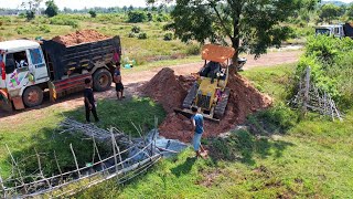 Clean water to make the way for the truck to enter the land, then clear the grass in the field.