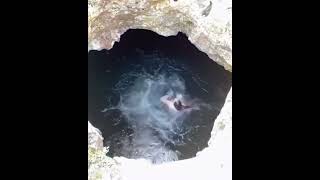 Jumping into Cenote Calavera in Tulum, Mexico