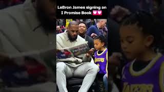 A wholesome moment, LeBron James signing a fan I Promise Book #lebronjames #lakers #shorts