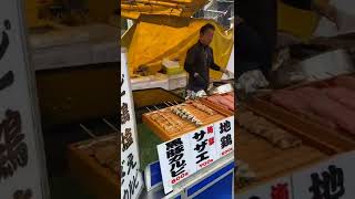 Tokyo street food. Grilled meT and seafood skewers at Tsukiji