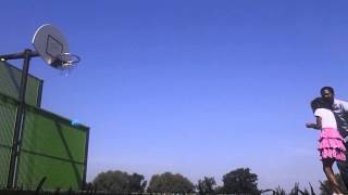 Father teaches daughter how to shoot hoops