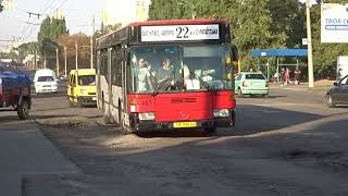 Bus Mercedes-Benz Castrosua CS.40 drives on a broken road. Red urban low-floor handsome man