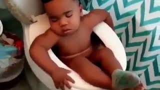 Baby Sleeps Comfortably On Toilet Seat