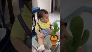 Baby playing with talking plant toy