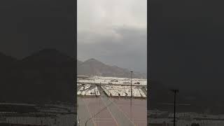 hajj site mina raining sky