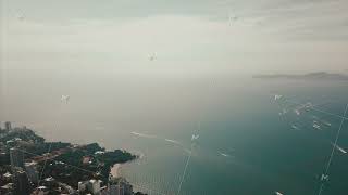 Aerial shot in the morning above the beach and sea with many tourist and boats. Video. Beautiful