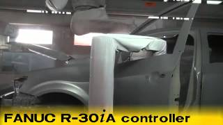 FANUC P 500iA and P 700iA robots prime paint and seal a car body