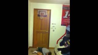 kid trying to slam dunk on mini hoop  FAIL