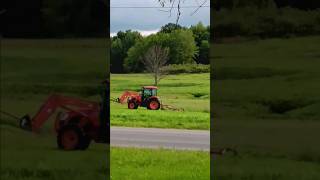 Orange Tractor Mowing Lawn