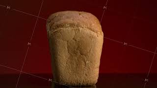 Close up of tasty baked bread slices with crispy crust lying on reflective surface isolated on red