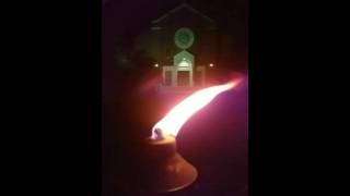 Slow motion flame in front of old church