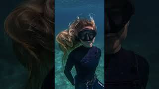 female freediver floating still underwater