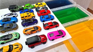 Various Diecast Model Cars Sliding Into The Yellow, Blue And Green Water *