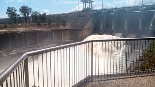 Wivenhoe dam - pan to spillway releasing from top viewing platform - one gate open - 16 October 2022