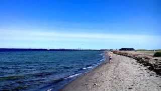 Plane landing at the Kastrup Airport in Copenhagen (beach view)