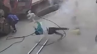 LiveLeak - Woman and child gets knocked down by an explosion tire