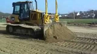 Cat D6K with Trimble laser leveling equipment trimming sports field stablized base .wmv