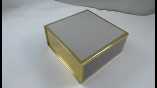 Golden magnetic folding box with white color.