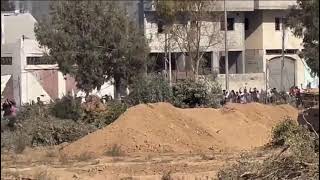 Gaza residents walk on the Israeli evacuation corridor heading south with white flags.