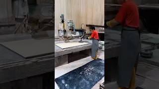 Polishing thin beige limestone slabs with a semi-automatic hand polisher for a flawless finish