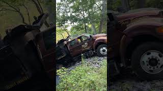 Dump truck falls through covered bridge