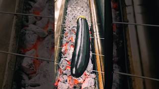 Cooking eggplant with eggs on coals.